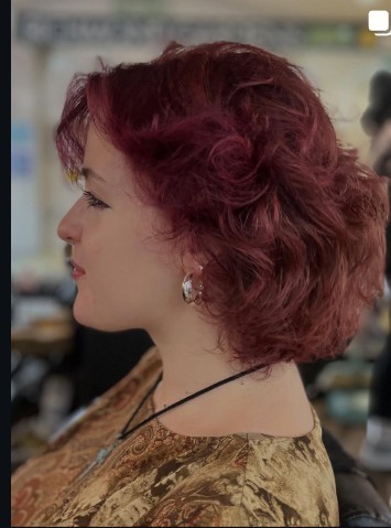 Burgundy curly hair with a deep red tone, freshly coloured