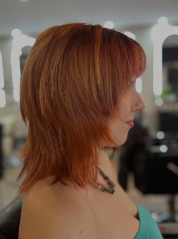 Sharp scarlet red bob with a blunt fringe, the cover look
