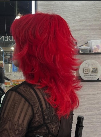 Deep red messy cut, layered with a soft fringe